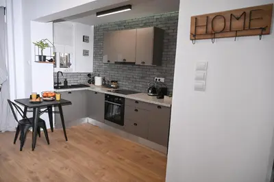 a kitchen with a table and a brick wall at Urban Loft by Neuvel in Athens