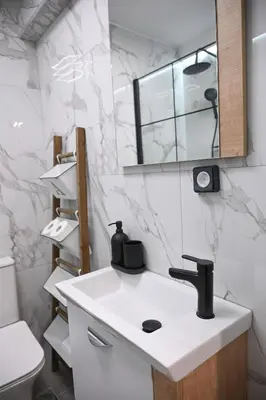 a bathroom with a white sink and a mirror at Urban Loft by Neuvel in Athens