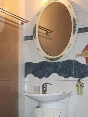 a bathroom with a sink and a mirror on the wall at Athens Riviera coast apartment in Athens
