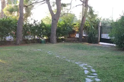 a stone path in the grass in a yard at Athens Riviera coast apartment in Athens