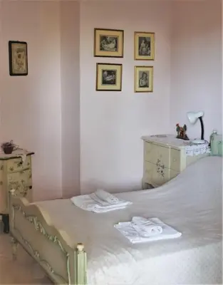 a bedroom with a bed with two towels on it at Athens Riviera coast apartment in Athens