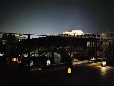 a view of a city at night from a balcony at A perfect spot in Athens