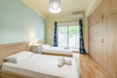 a bedroom with two beds and a window at A perfect spot in Athens
