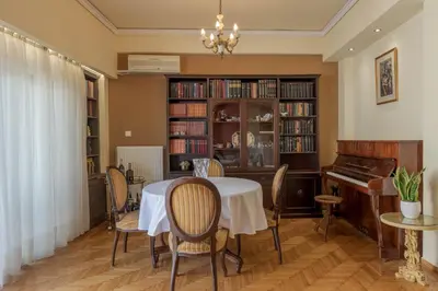 a dining room with a table and a piano at A perfect spot in Athens
