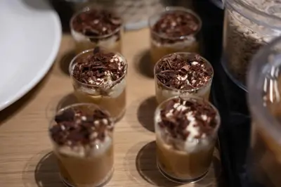 a group of little cups filled with chocolate desserts at Nema Hotel Athens in Athens