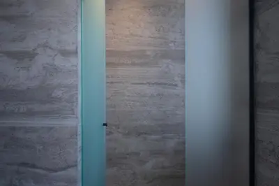 an open door in a room with a stone wall at Nema Hotel Athens in Athens