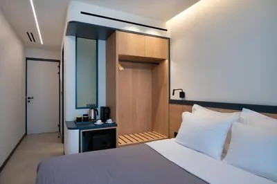 a hotel room with a bed and a bathroom at Nema Hotel Athens in Athens