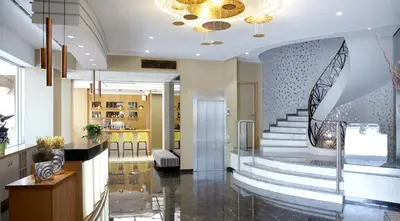 a lobby with a staircase in a building at Athens Tiare by Mage Hotels in Athens