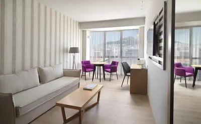 a living room with a couch and a table at Athens Tiare by Mage Hotels in Athens