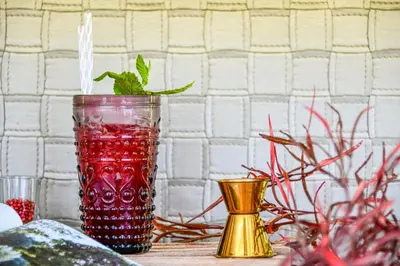a red drink in a glass sitting on a table at Athens Tiare by Mage Hotels in Athens