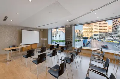 a meeting room with chairs and a projection screen at Athens Tiare by Mage Hotels in Athens