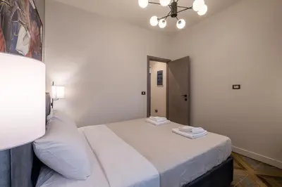 a bedroom with a large bed with white sheets at Exarcheia Vibe Penthouse 1 in Athens