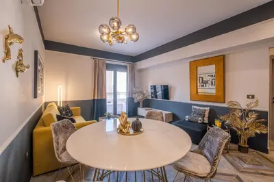 a living room with a table and a couch at Exarcheia Vibe Penthouse 1 in Athens