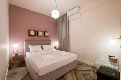 a bedroom with a bed with two towels on it at Exarcheia Vibe Penthouse 1 in Athens