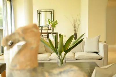 a living room with a couch and a table at Plaza Resort in Anavissos