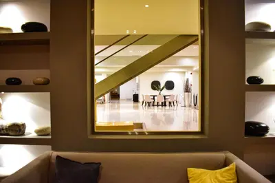 a large mirror in a living room with a couch at Plaza Resort in Anavissos