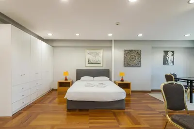 a bedroom with a bed and two chairs at Arditou Akropolis Apartments-Suites in Athens