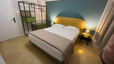 a bedroom with a large white bed in a room at Crown Syntagma Apartment in Athens
