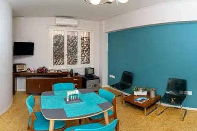 a living room with a table and chairs at Crown Syntagma Apartment in Athens