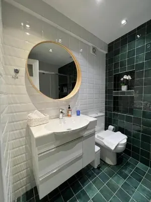a bathroom with a sink and a mirror and a toilet at Crown Syntagma Apartment in Athens