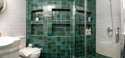 a green tiled bathroom with a toilet and a shower at Crown Syntagma Apartment in Athens