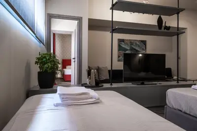 a bedroom with a tv and a bed with towels at Athens Exarcheia Vibe 3 in Athens
