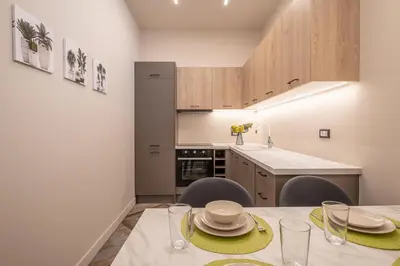 a kitchen with a table and two chairs and a counter at Athens Exarcheia Vibe 3 in Athens