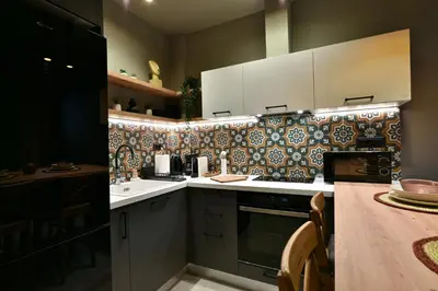 a kitchen with a stove and a sink and a counter at NewVintage Apartment in Athens