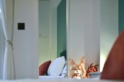 a reflection of a bed in a mirror at NewVintage Apartment in Athens