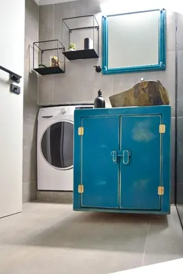 a blue cabinet next to a washing machine in a room at NewVintage Apartment in Athens