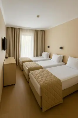 a hotel room with three beds and a television at Hotel London in Athens