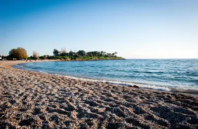 a sandy beach with the ocean in the background at Hotel London in Athens