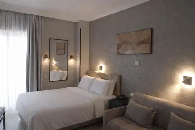 a hotel room with a bed and a couch at Hotel London in Athens