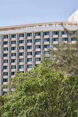 an office building with trees in front of it at Urban Heights 3BD Apt, next to Hilton in Athens