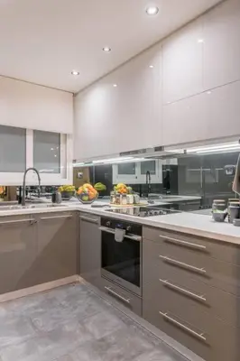 a kitchen with stainless steel appliances and white cabinets at The HostMaster Artistic Inn in Athens