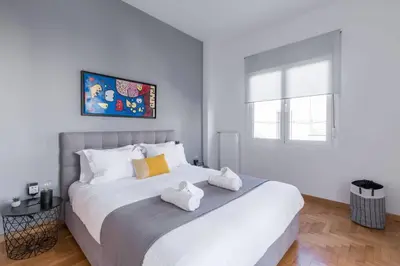 a bedroom with a large bed with towels on it at The HostMaster Artistic Inn in Athens