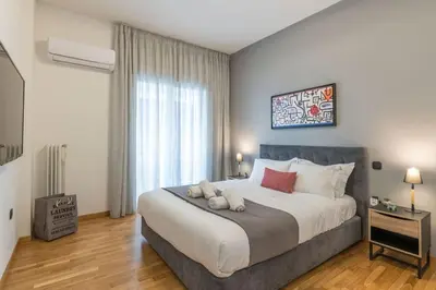 a bedroom with a large bed and a large window at The HostMaster Artistic Inn in Athens