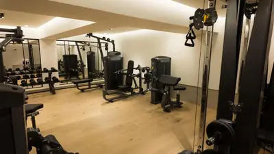 a gym with several treadmills and weights at Coral Hotel Athens in Athens