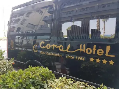 a hotel sign on the side of a bus at Coral Hotel Athens in Athens