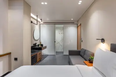 a bedroom with a bed and a living room at Amazon Hotel in Athens