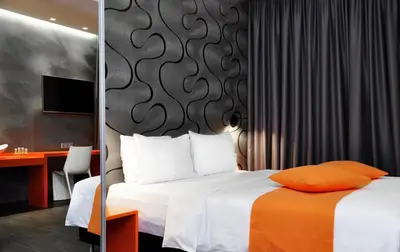 a hotel room with a bed and a desk at Amazon Hotel in Athens