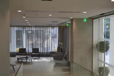 a lobby with chairs and tables in a building at Amazon Hotel in Athens