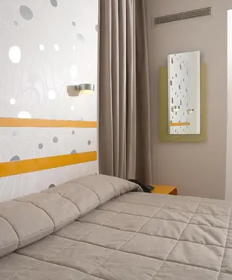 a bedroom with a bed and a curtain and a window at Amazon Hotel in Athens