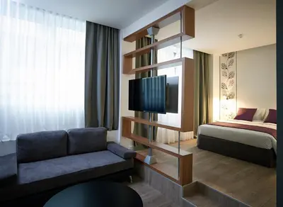 a hotel room with a couch and a bed at Amazon Hotel in Athens
