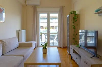 a living room with a couch and a table at Cozy apartment in Pangrati area! in Athens