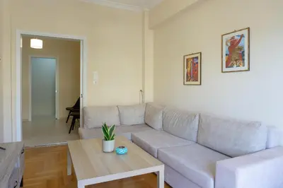 a living room with a couch and a table at Cozy apartment in Pangrati area! in Athens