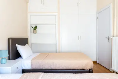 a bedroom with two beds and a window at Cozy apartment in Pangrati area! in Athens