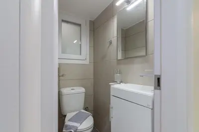 a small bathroom with a toilet and a sink at Cozy apartment in Pangrati area! in Athens