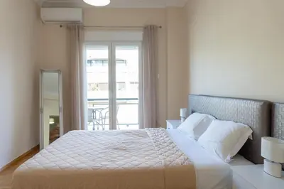 a bedroom with a large bed and a window at Cozy apartment in Pangrati area! in Athens