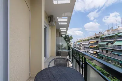 a balcony with a table and a view of buildings at Cozy apartment in Pangrati area! in Athens